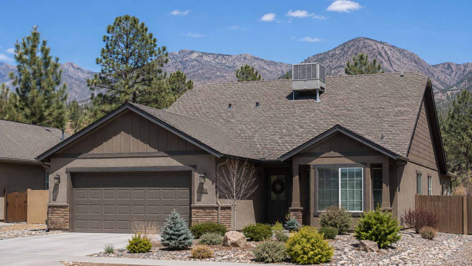 A rooftop AC unit on top of a residential home with asphalt shingles in Northern Arizona.