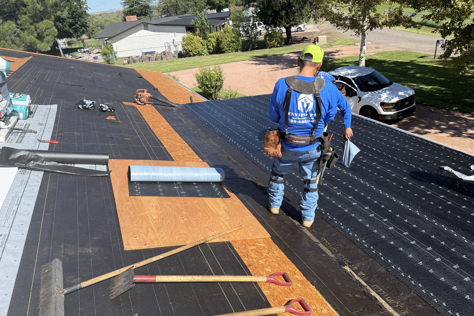 Laying underlayment Enviro Pro crew laying underlayment on a full roof replacement