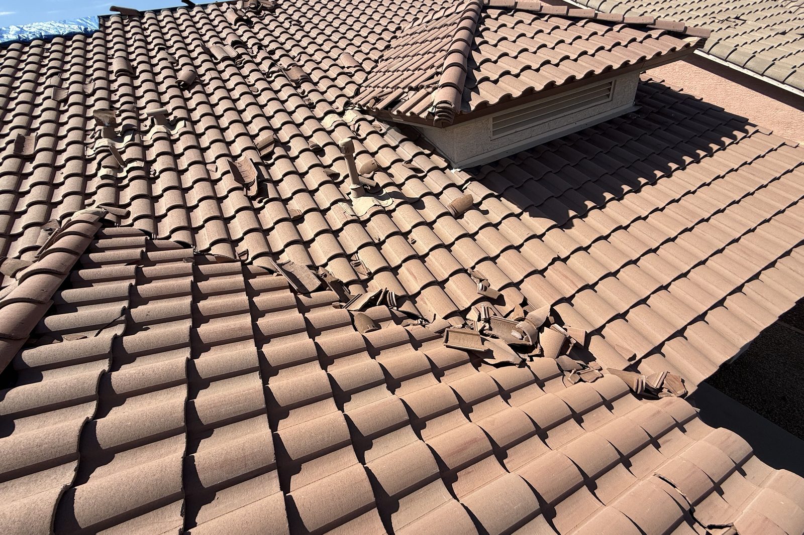 Tile roof repair – before Cracked and slipped roof tiles on a Northern Arizona home before tile repair